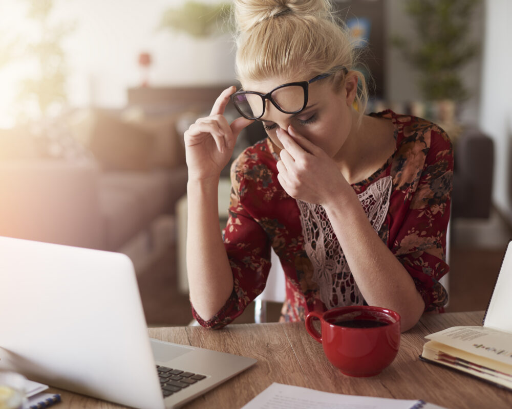 A person sitting at the desk stressed at work